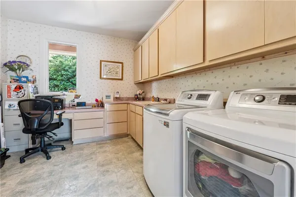 a spacious bedroom with a bed and a large window