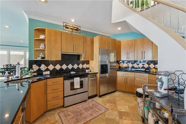 a bathroom with a granite countertop sink mirror vanity and a bathtub