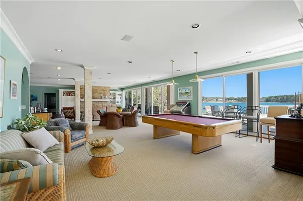 a spacious bathroom with a granite countertop toilet sink and mirror