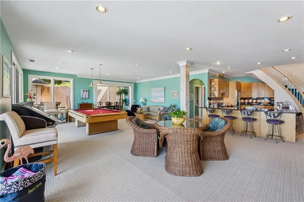 a view of a house with swimming pool and sitting area