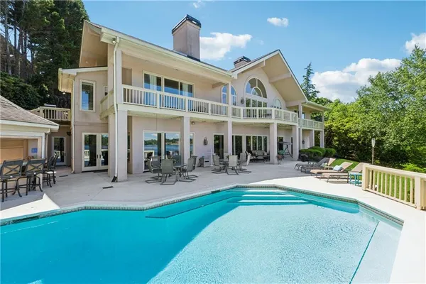 a view of a lake with a house and a yard