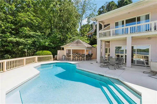 a view of a swimming pool with a yard