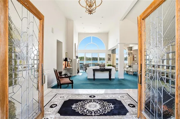 a living room with furniture a fireplace and a large window