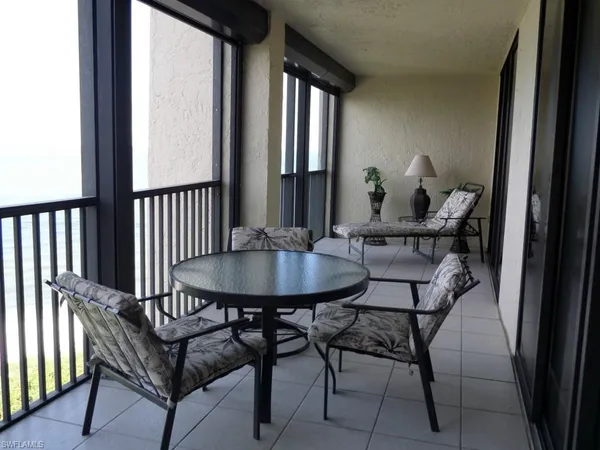 a view of a balcony dining table and chairs