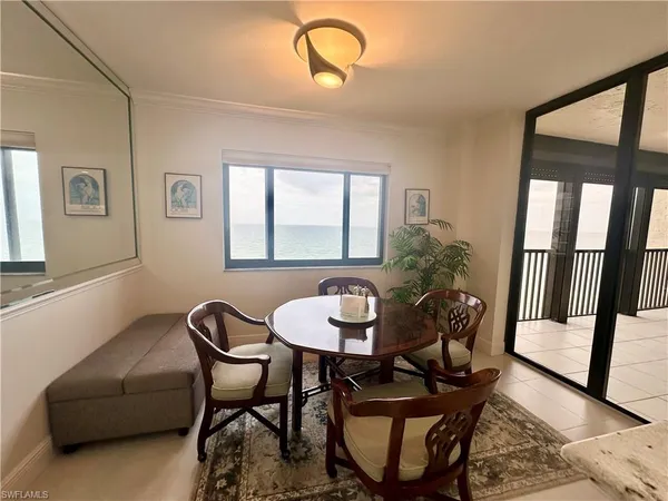 a dining room with furniture and window