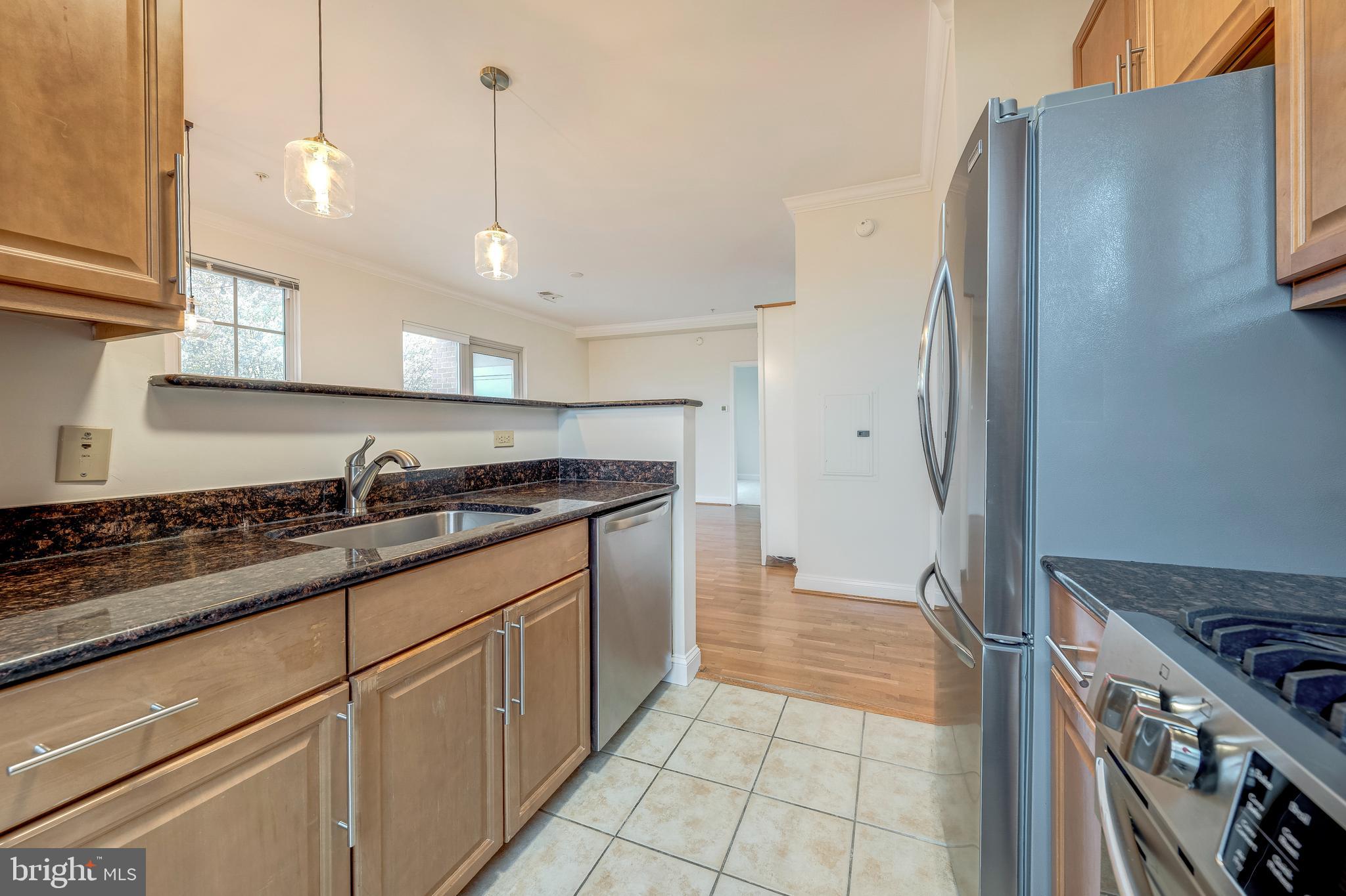 11770 Sunrise Valley Drive, Unit 321 Reston, VA 20191 - Photo 12 of 36 a kitchen with stainless steel appliances granite countertop a sink stove and refrigerator