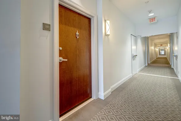 a view of a hallway with wooden shelves