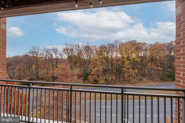 a view of a balcony with wooden fence