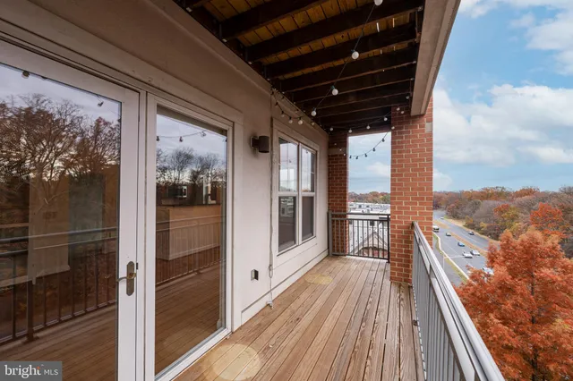 a view of balcony with a floor to ceiling window with wooden floor