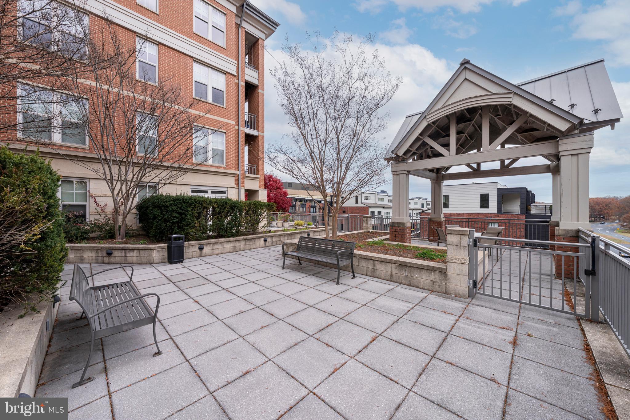 11770 Sunrise Valley Drive, Unit 321 Reston, VA 20191 - Photo 26 of 36 a view of a patio with couches table and chairs and potted plants