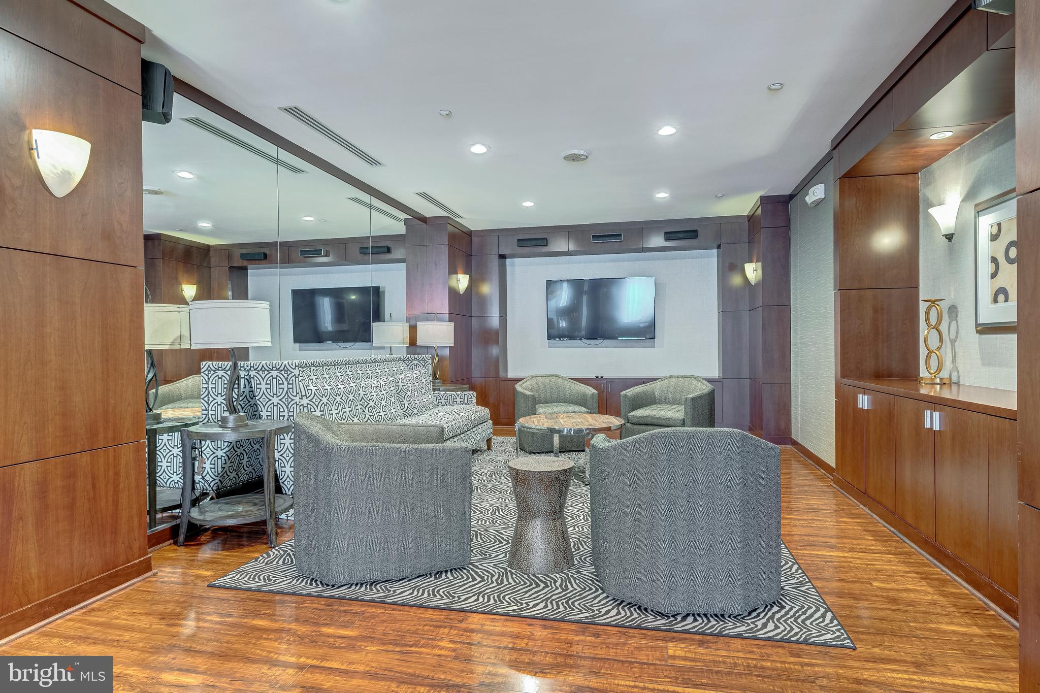 11770 Sunrise Valley Drive, Unit 321 Reston, VA 20191 - Photo 29 of 36 a living room with a couch and a dining table with wooden floor
