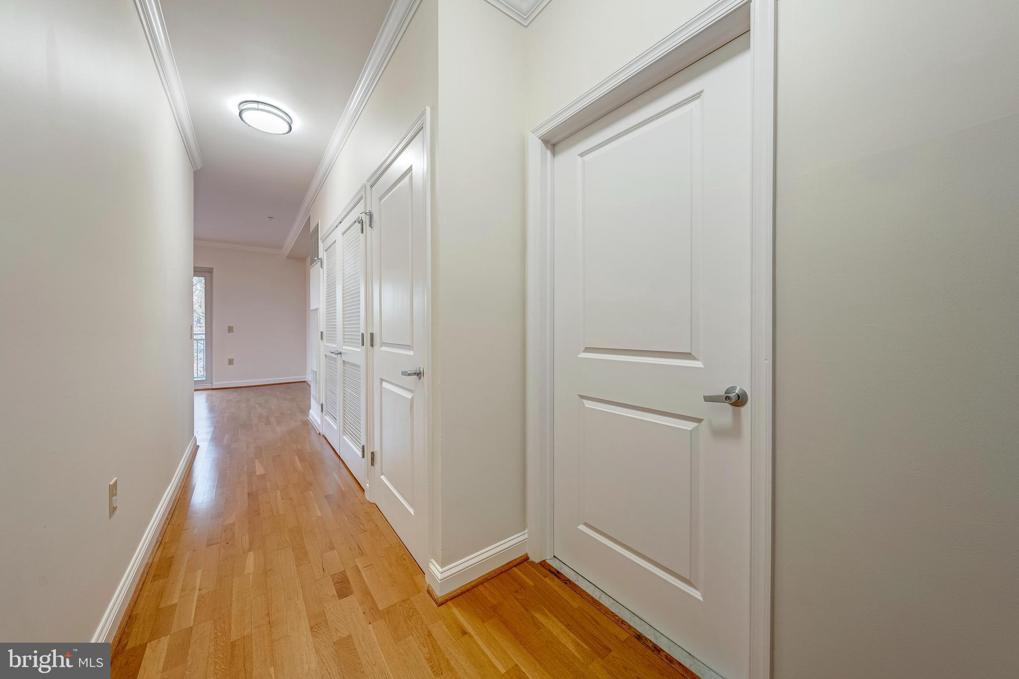 11770 Sunrise Valley Drive, Unit 321 Reston, VA 20191 - Photo 3 of 36 a view of a hallway with wooden floor