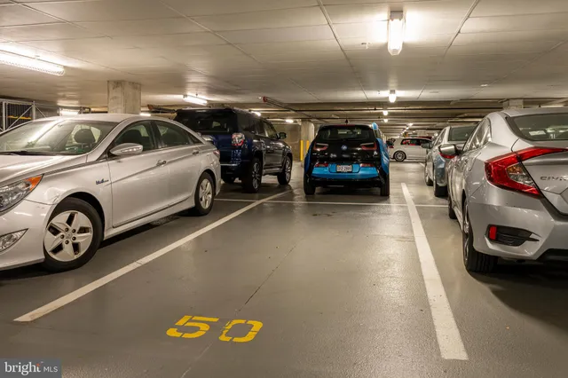 a view of parking garage with cars parked