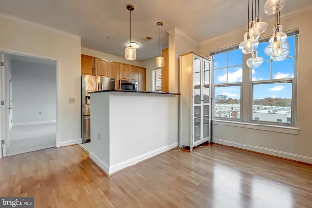 a view of a kitchen with wooden floor and windows