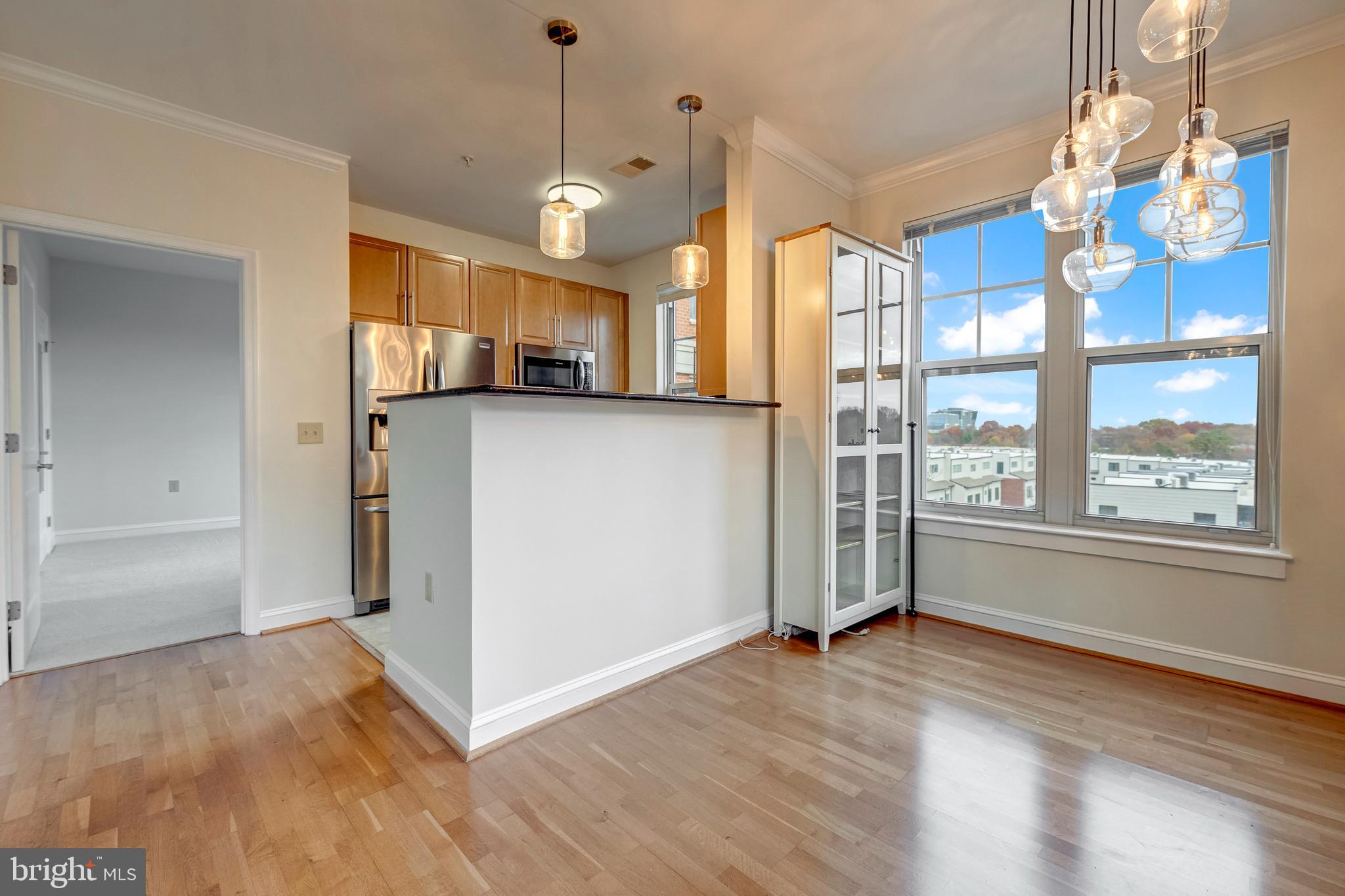 11770 Sunrise Valley Drive, Unit 321 Reston, VA 20191 - Photo 9 of 36 a view of a kitchen with wooden floor and windows