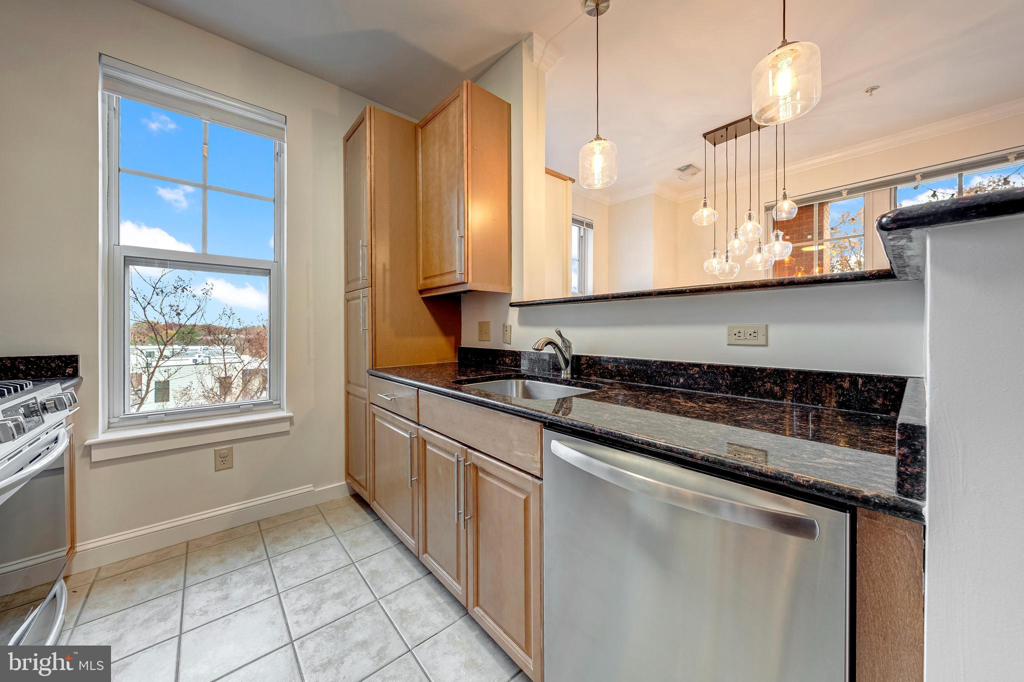 11770 Sunrise Valley Drive, Unit 321 Reston, VA 20191 - Photo 10 of 36 a kitchen with stainless steel appliances granite countertop a sink and a stove