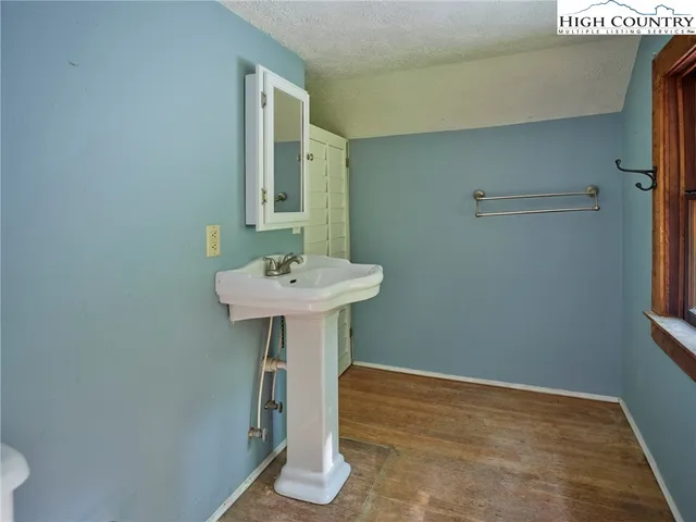 a bathroom with a sink a mirror and shower