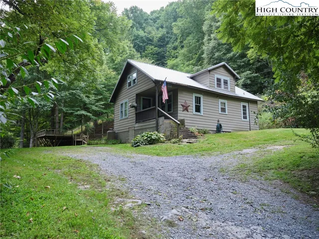 a view of a house with yard and a garden