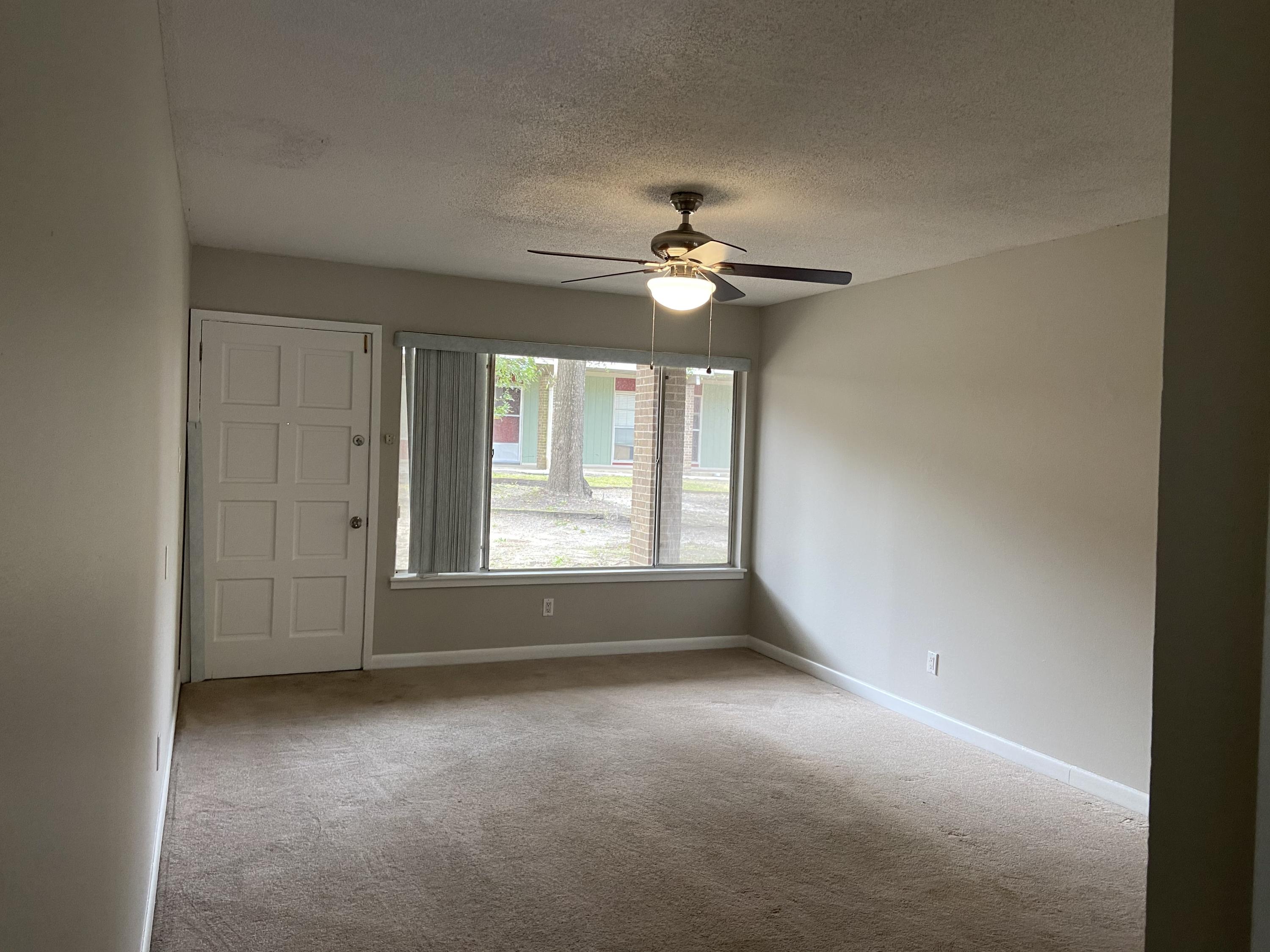 210 Pelham Road, Unit 114A Fort Walton Beach, FL 32547 - Photo 4 of 9 a view of room with a ceiling fan and a window