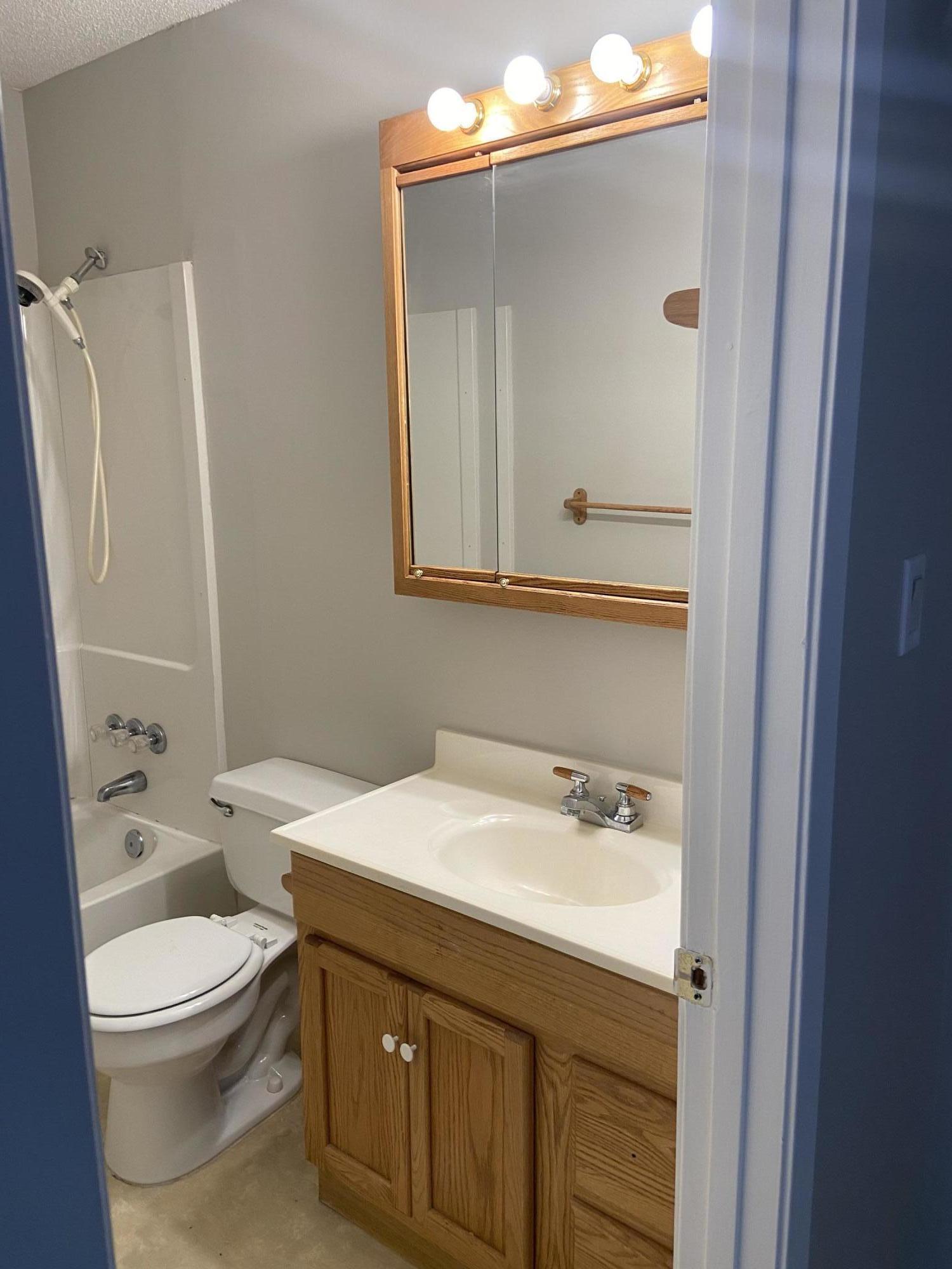 210 Pelham Road, Unit 114A Fort Walton Beach, FL 32547 - Photo 7 of 9 a bathroom with a sink a toilet and shower
