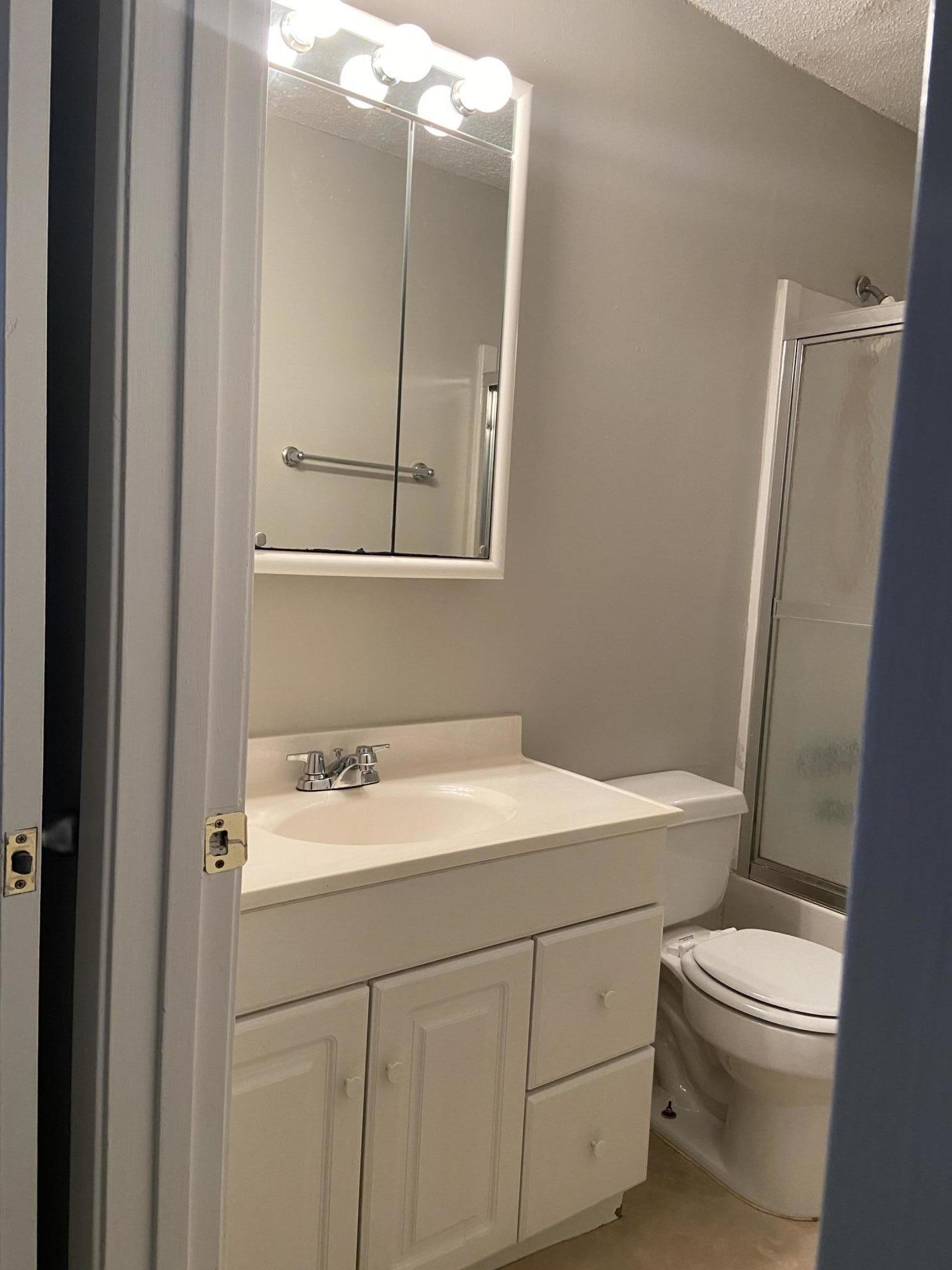 210 Pelham Road, Unit 114A Fort Walton Beach, FL 32547 - Photo 9 of 9 a bathroom with a sink a toilet and vanity