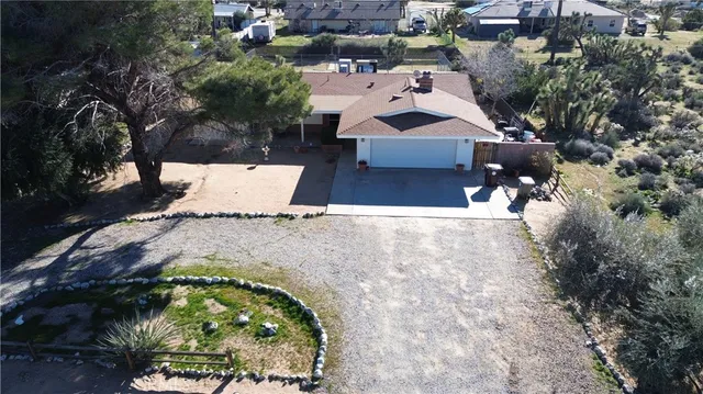 an aerial view of a house with a yard and trees