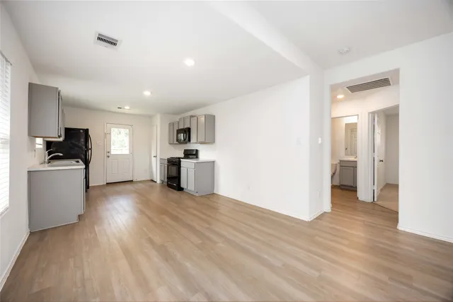 a view of kitchen with wooden floor and electronic appliances