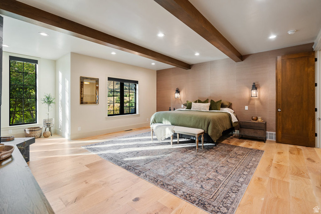 1141 South Oak Leaf Lane Springville, UT 84663 - Photo 52 of 147 Spacious Primary bedroom featuring exposed wood beams, light wood-finish flooring, a textured accent wall, and recessed lighting