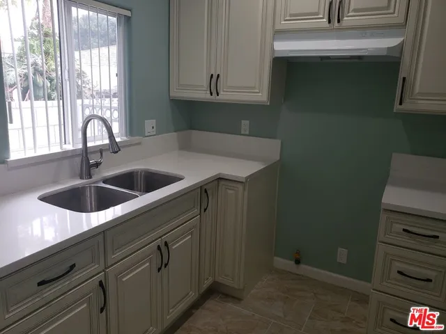 a kitchen with a sink and cabinets
