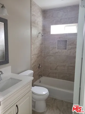 a bathroom with a toilet a sink and bathtub