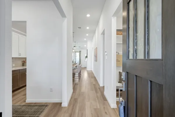 a view of a hallway with wooden floor and staircase