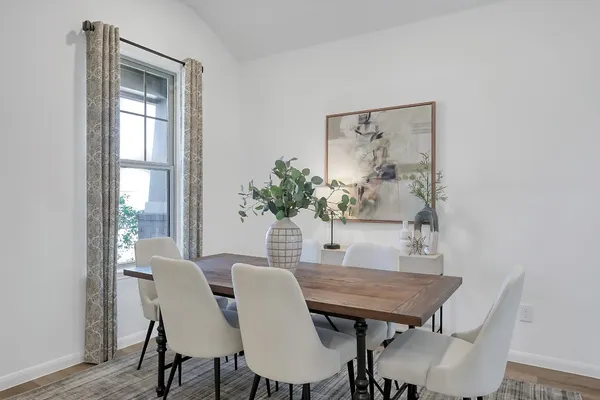 a dining room with furniture and window