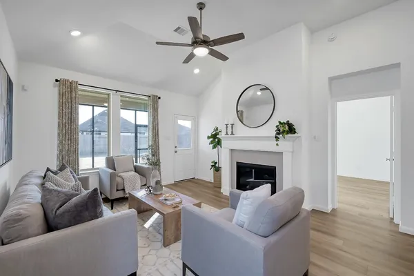 a living room with furniture a fireplace and a floor