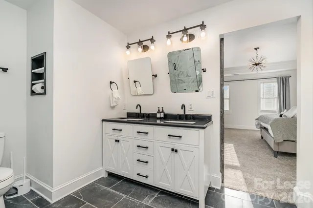 a spacious bathroom with a sink and a mirror