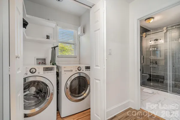 a view of a hallway with washer and dryer
