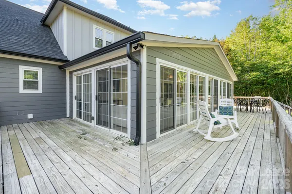 a view of balcony with wooden floor and seating space
