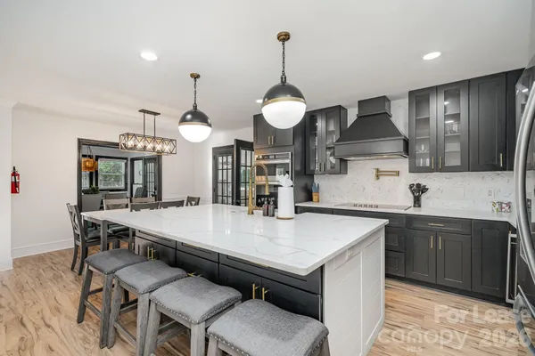 a large kitchen with a table and chairs