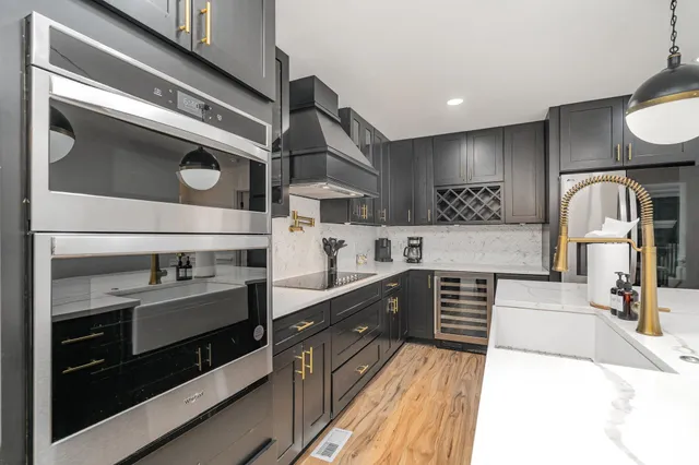 a kitchen with stainless steel appliances sink and cabinets