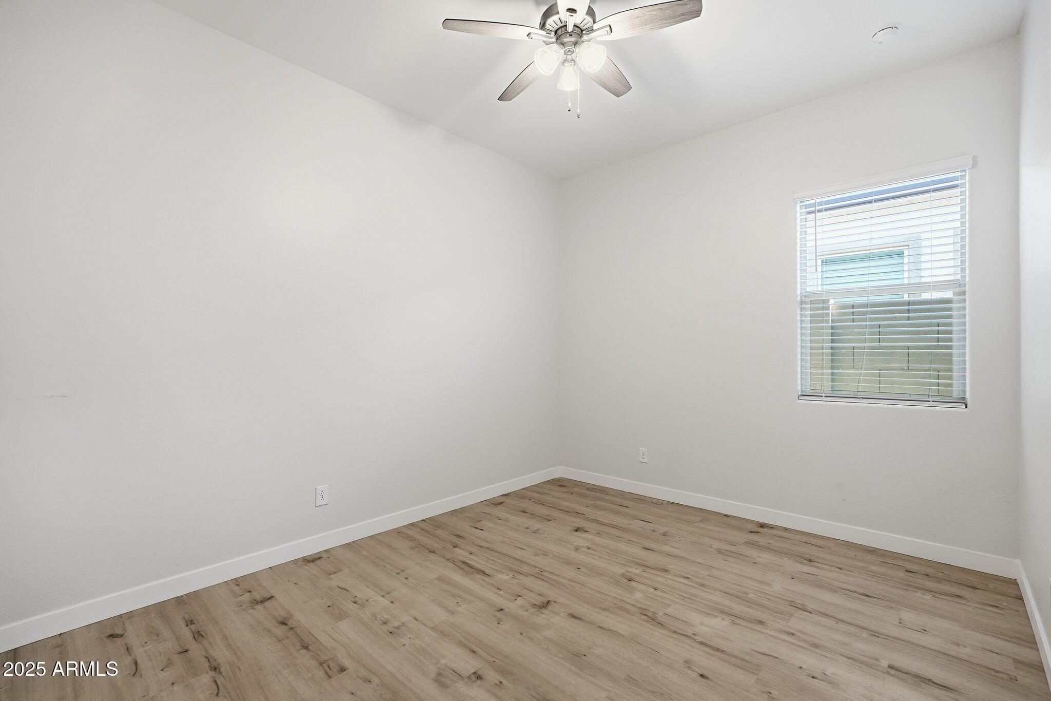 9749 East Tahoe Avenue Mesa, AZ 85212 - Photo 15 of 41 wooden floor in an empty room with a window