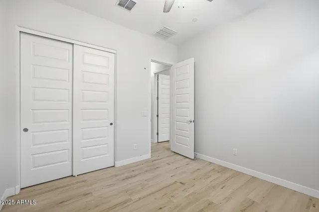an empty room with closet area