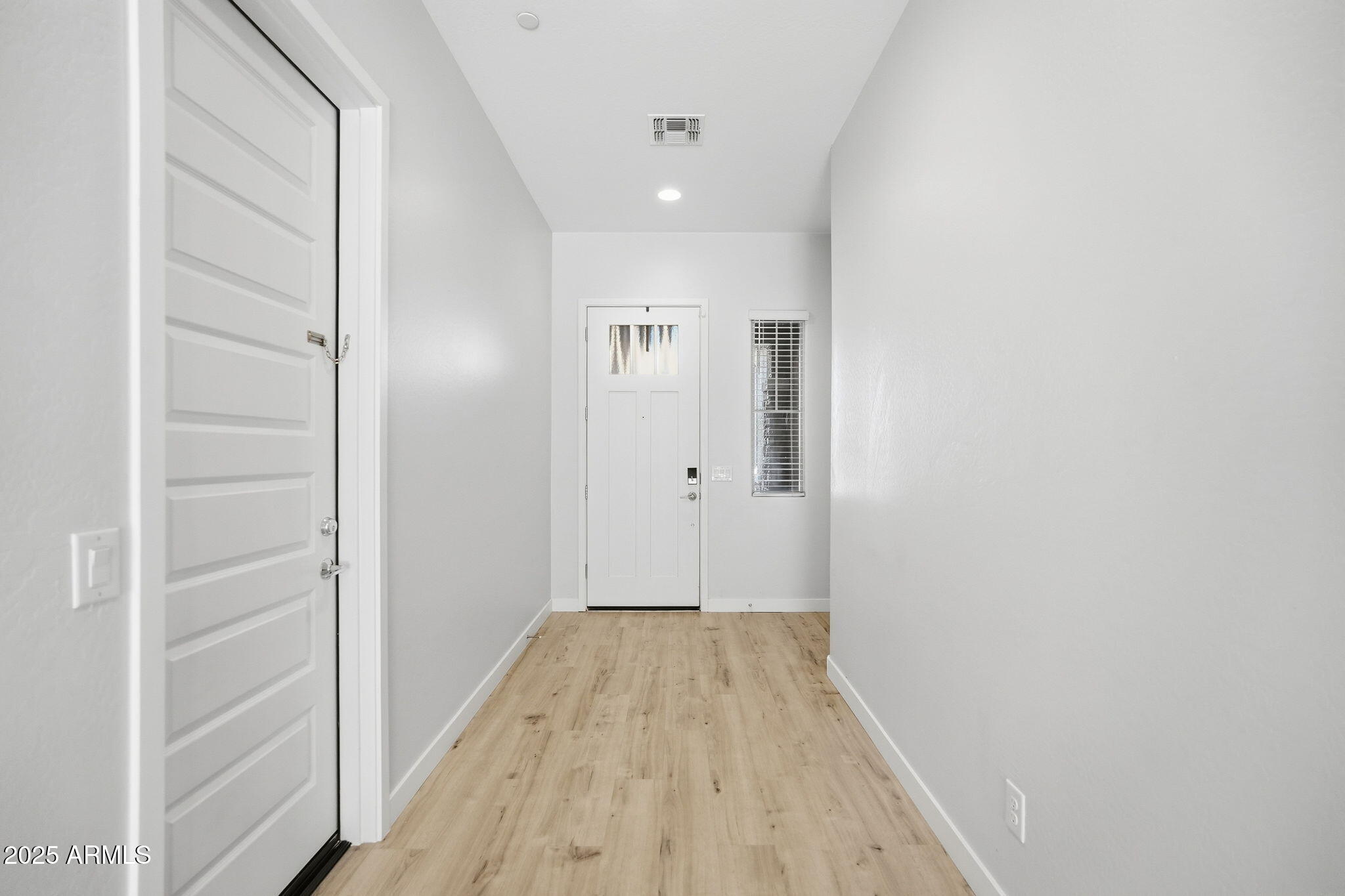 9749 East Tahoe Avenue Mesa, AZ 85212 - Photo 22 of 41 a view of a hallway with wooden floor