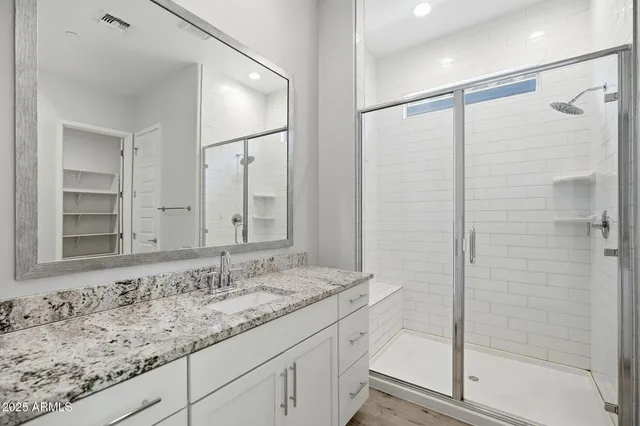 a bathroom with a granite countertop sink mirror and double