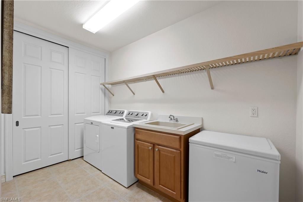 8613 Champions Point, Unit 302 Naples, FL 34113 - Photo 25 of 41 a utility room with dryer and washer