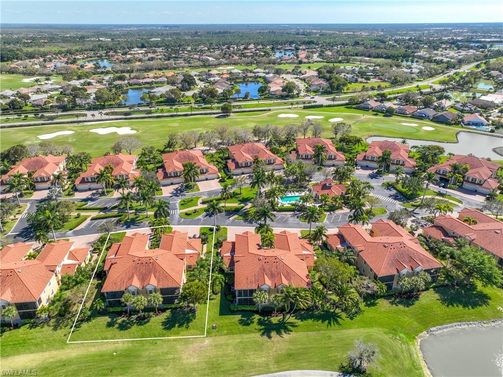 8613 Champions Point, Unit 302 Naples, FL 34113 - Photo 30 of 41 an aerial view of city lake and trees all around