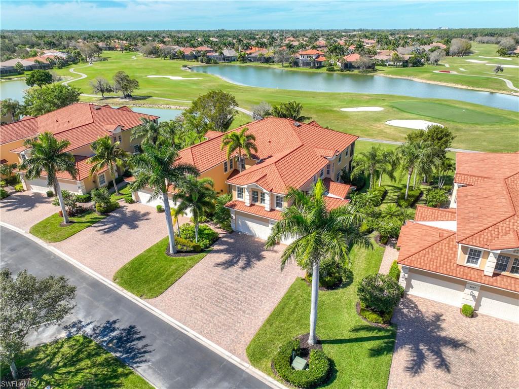 8613 Champions Point, Unit 302 Naples, FL 34113 - Photo 3 of 41 an aerial view of residential houses with outdoor space and lake view