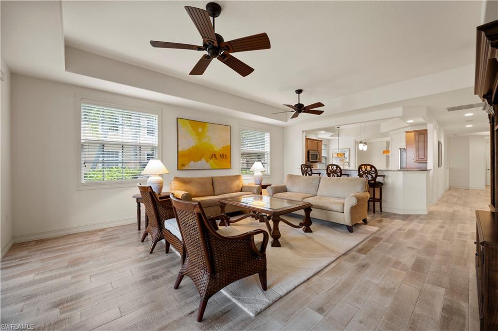 8613 Champions Point, Unit 302 Naples, FL 34113 - Photo 10 of 41 a living room with furniture and a window