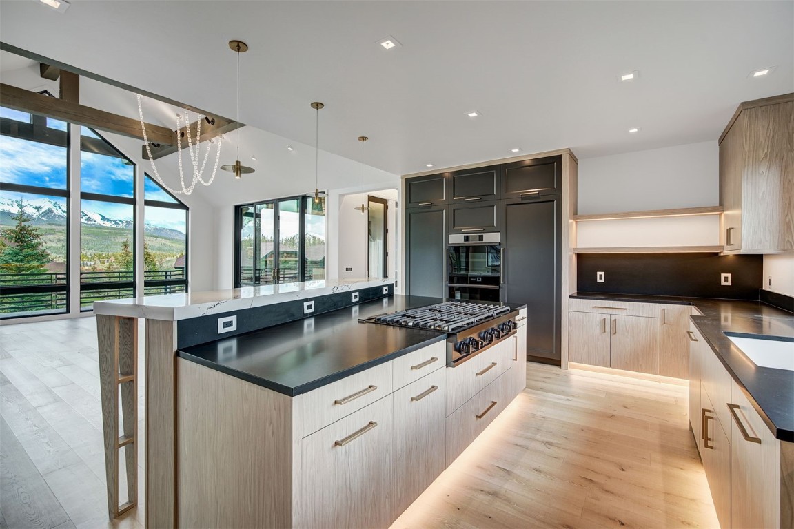 294 Gold Run Road Breckenridge, CO 80424 - Photo 16 of 50 a large kitchen with granite countertop a sink and a stove top oven