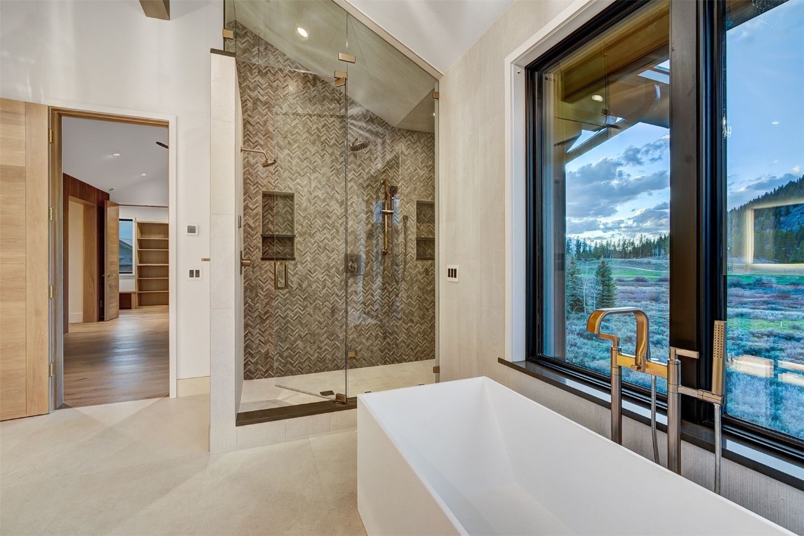 294 Gold Run Road Breckenridge, CO 80424 - Photo 23 of 50 a bathroom with a glass shower door and a large window