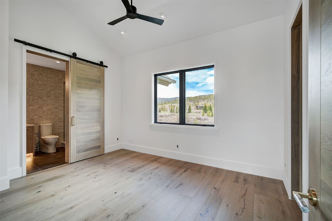 294 Gold Run Road Breckenridge, CO 80424 - Photo 28 of 50 an empty room with wooden floor and windows