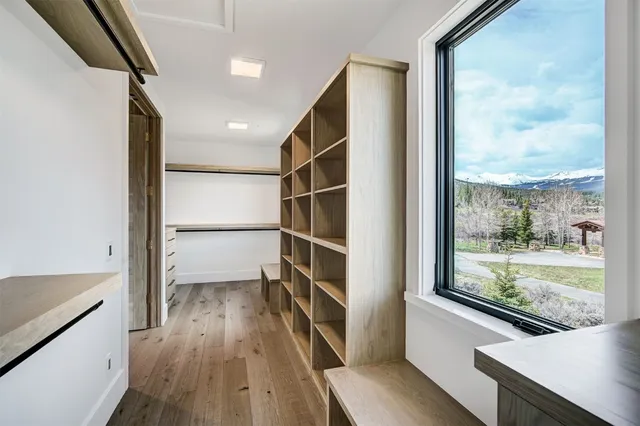 a view of a kitchen with wooden floor and a window